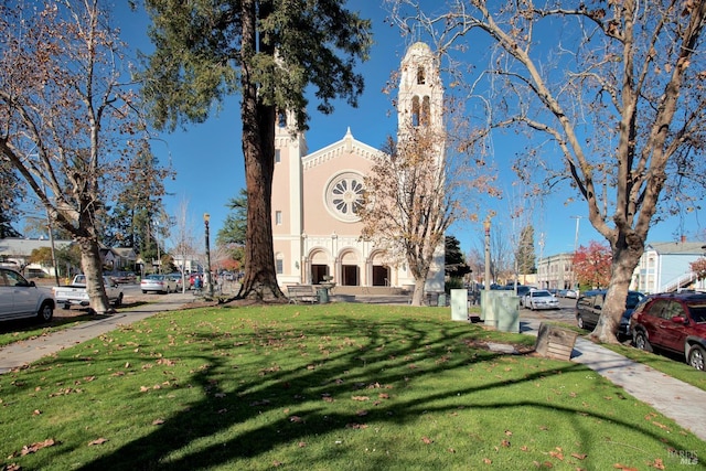 view of property's community with a lawn