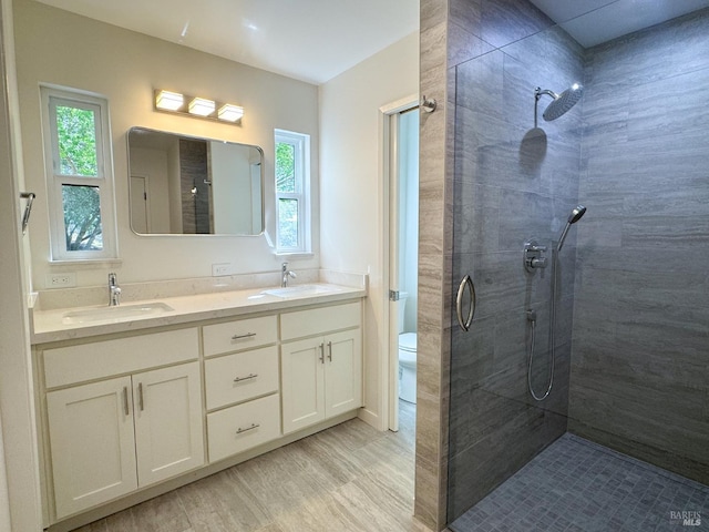 8 Shon Ct, Novato, CA 94947 - bathroom featuring a tile shower, healthy amount of natural light, double vanity, and wood finished floors
