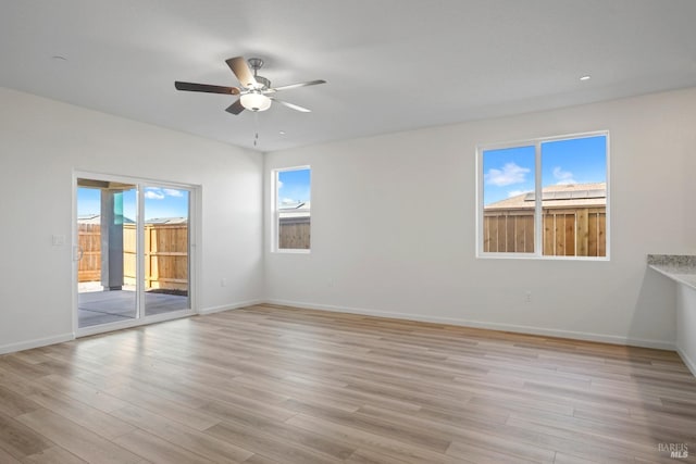 spare room featuring light wood-style flooring, baseboards, recessed lighting, and ceiling fan