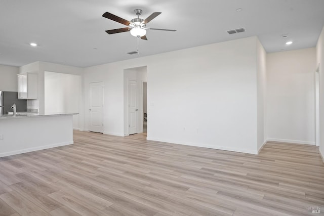 unfurnished living room featuring recessed lighting, light wood-type flooring, visible vents, and a ceiling fan