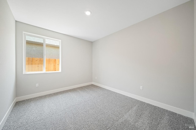 spare room with recessed lighting, carpet, and baseboards