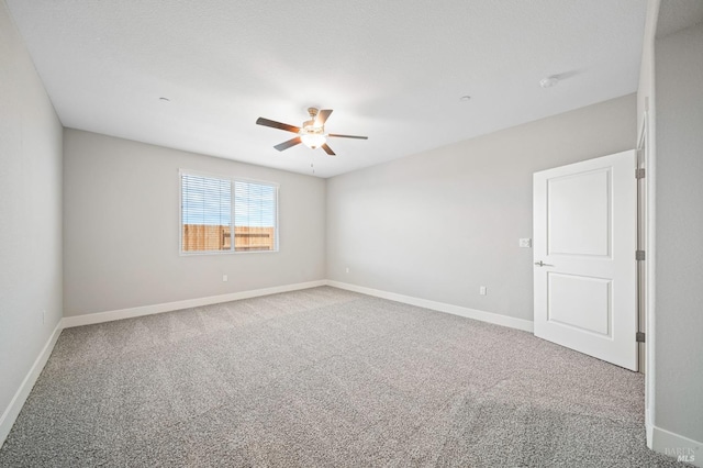 unfurnished room with ceiling fan, carpet floors, and baseboards
