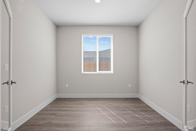 interior space featuring recessed lighting, baseboards, wood finished floors, and a closet