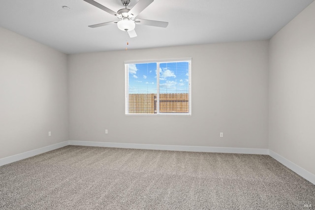 empty room featuring carpet, baseboards, and ceiling fan
