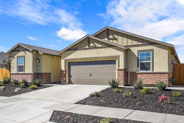 craftsman house with board and batten siding, fence, a garage, stucco siding, and brick siding