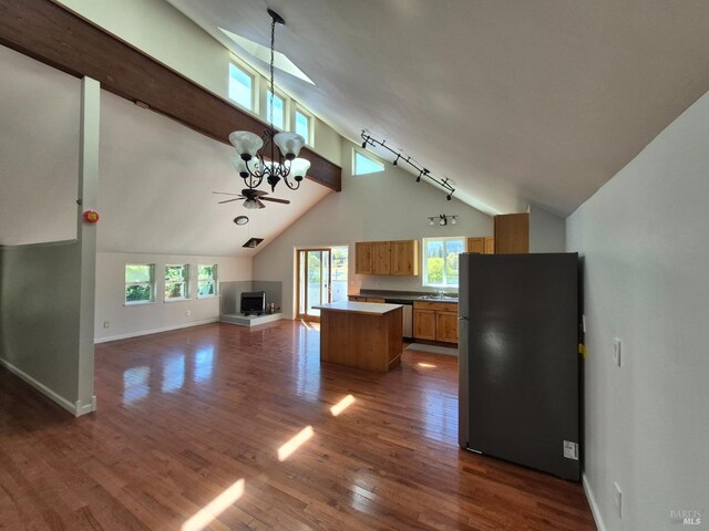 kitchen featuring a center island, dark wood-style floors, open floor plan, ceiling fan with notable chandelier, and appliances with stainless steel finishes