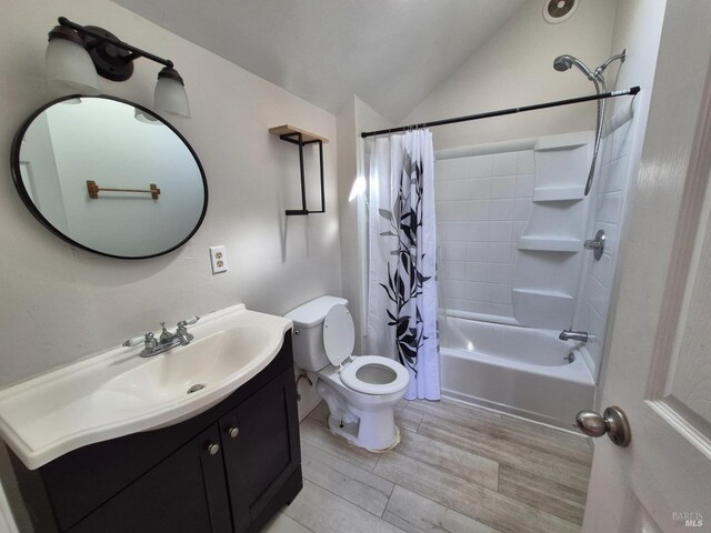full bathroom featuring lofted ceiling, wood finished floors, toilet, vanity, and shower / bath combo