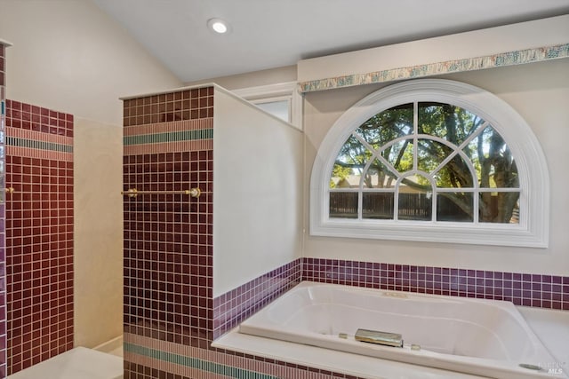 bathroom with a bath and recessed lighting