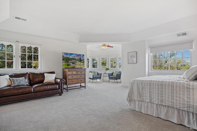 carpeted bedroom featuring visible vents and ceiling fan