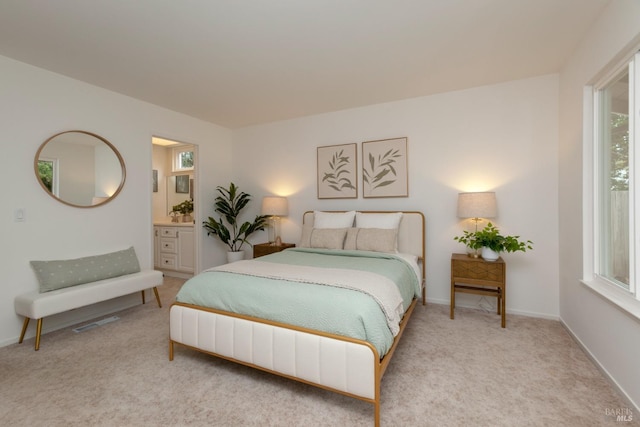 bedroom with carpet flooring, multiple windows, and baseboards