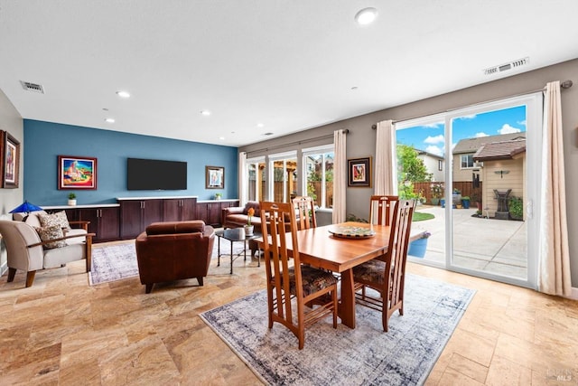 dining area with stone tile floors, visible vents, and recessed lighting