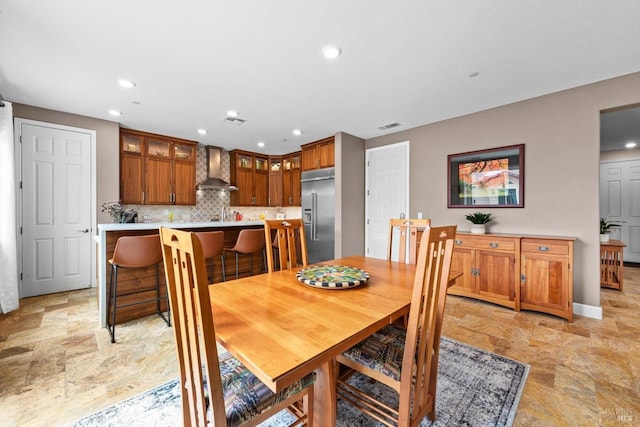 dining room featuring visible vents, recessed lighting, and stone finish flooring