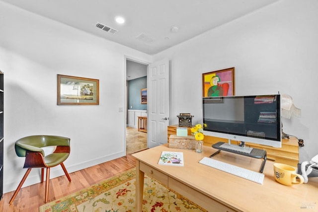 office area with visible vents, wood finished floors, and baseboards