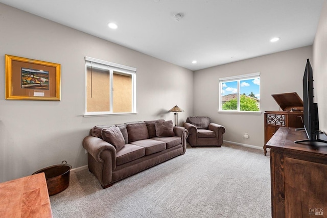 living area with recessed lighting, carpet floors, and baseboards