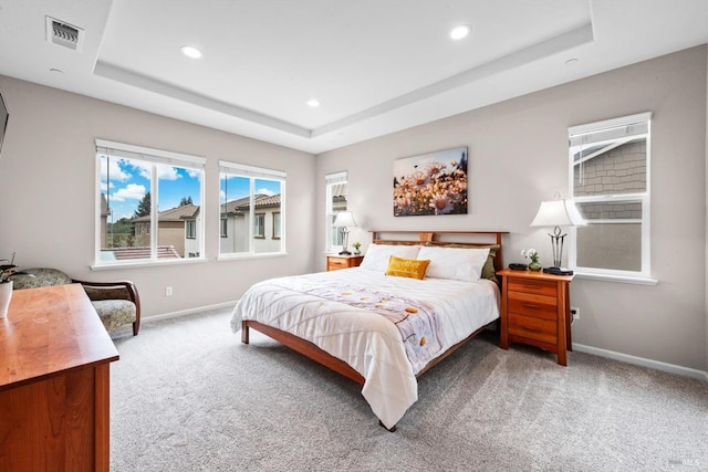 bedroom with visible vents, a tray ceiling, baseboards, carpet floors, and recessed lighting