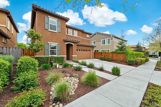view of front of home featuring stucco siding, a tiled roof, fence, concrete driveway, and an attached garage