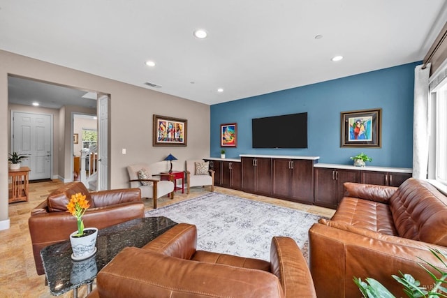 living room with recessed lighting, visible vents, and baseboards