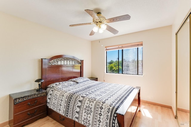 bedroom with baseboards, a ceiling fan, a closet, and light wood-style flooring
