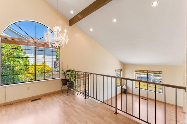 hallway featuring a chandelier, visible vents, vaulted ceiling with beams, and wood finished floors