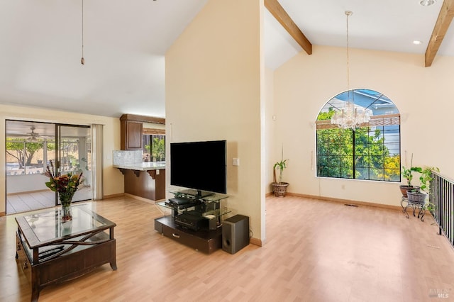 living room featuring an inviting chandelier, high vaulted ceiling, light wood finished floors, and beam ceiling