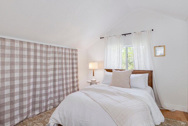 bedroom with lofted ceiling