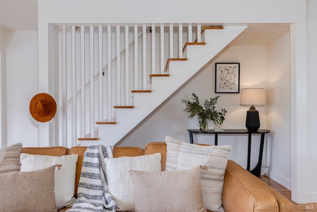 stairs with wood finished floors and baseboards