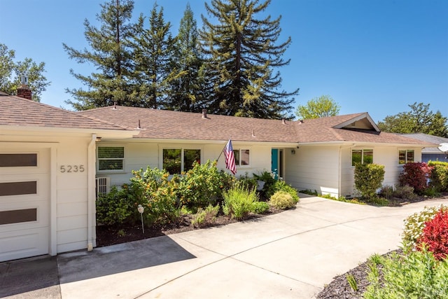 single story home with a chimney and a shingled roof