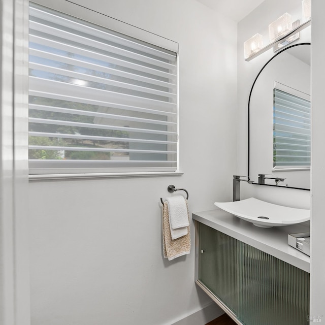 bathroom with a sink and baseboards