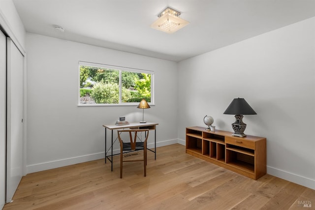 home office featuring baseboards and light wood-style flooring