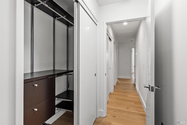 hall with light wood finished floors, recessed lighting, and baseboards