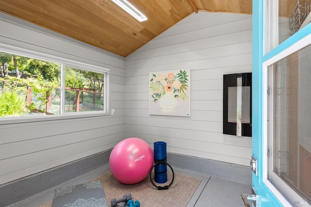 exercise area featuring wood walls, vaulted ceiling, and wooden ceiling