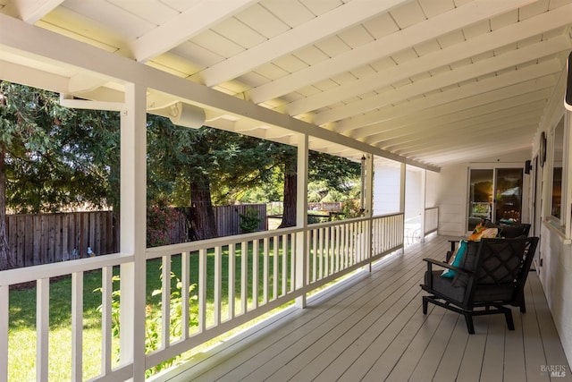 wooden deck with fence and a lawn