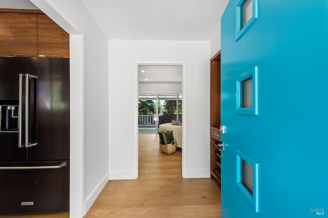 entryway with baseboards and light wood-type flooring