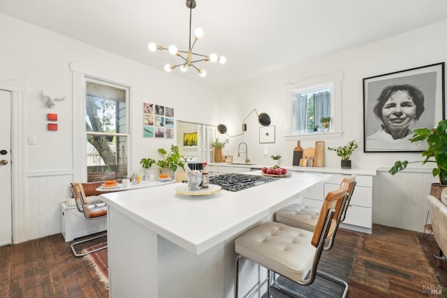 kitchen with light countertops, dark wood-style floors, and a wealth of natural light