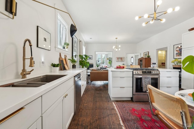 kitchen with a sink, dark wood-style floors, a notable chandelier, and stainless steel appliances