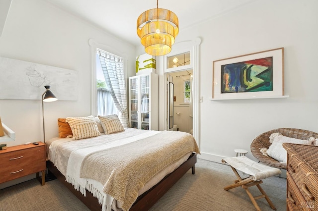 bedroom with baseboards, carpet flooring, and a notable chandelier