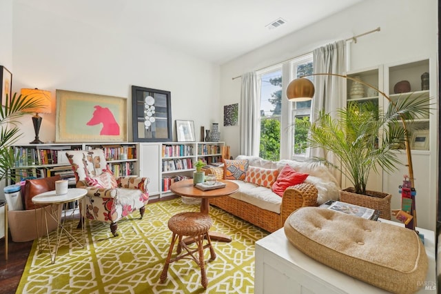 sitting room with visible vents and wood finished floors