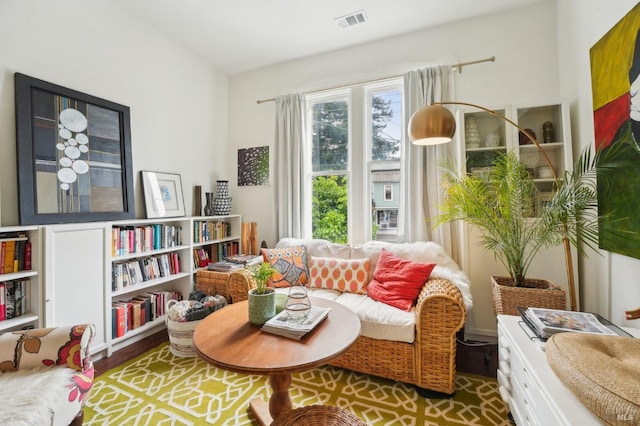 sitting room with visible vents and wood finished floors
