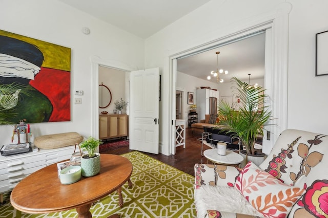 living area featuring dark wood finished floors and a notable chandelier