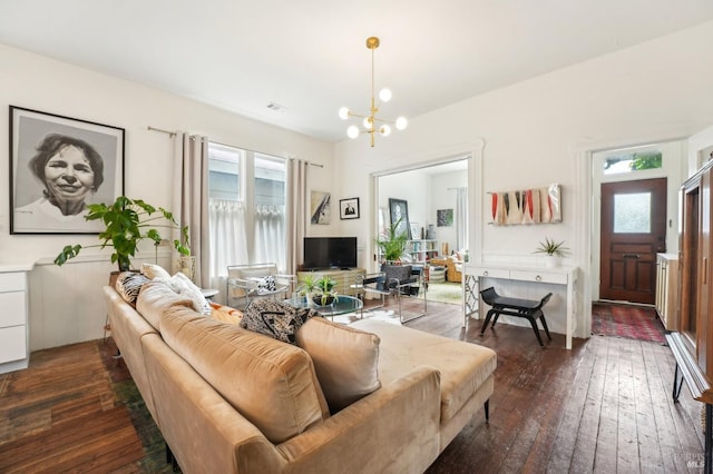 living area with dark wood-type flooring, visible vents, a wealth of natural light, and an inviting chandelier