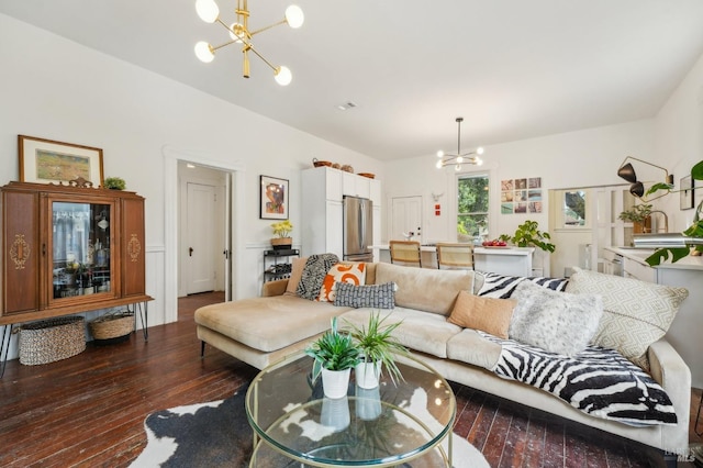 living area with a notable chandelier and hardwood / wood-style floors