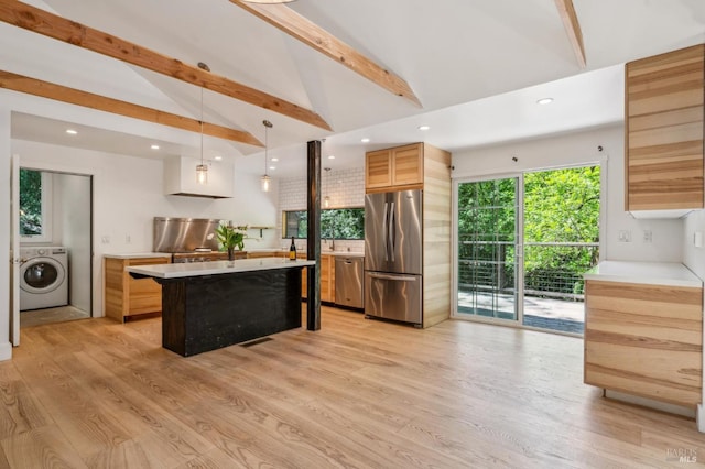 kitchen featuring recessed lighting, stainless steel appliances, light countertops, washer / dryer, and light wood-style flooring