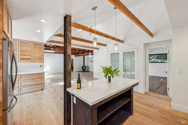 kitchen with open shelves, lofted ceiling with beams, light wood finished floors, light countertops, and freestanding refrigerator