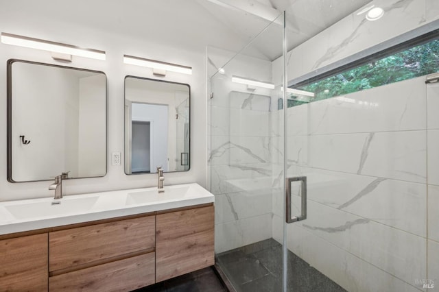 bathroom featuring a sink, double vanity, and a stall shower