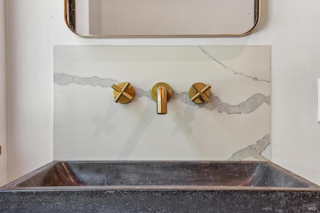 interior details with a washtub and a sink