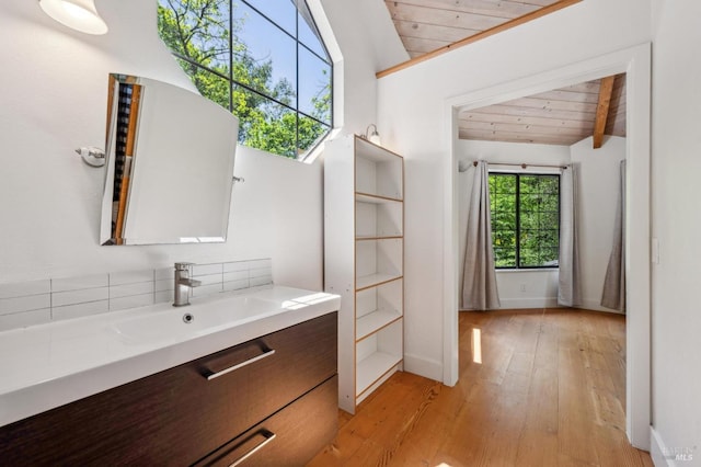 bathroom with wood-type flooring, vanity, wooden ceiling, and lofted ceiling with beams