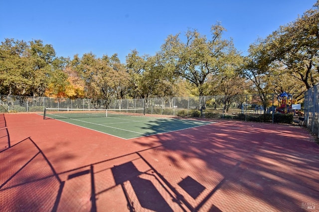 view of sport court featuring fence