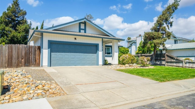 ranch-style house featuring concrete driveway, a front lawn, fence, and a garage
