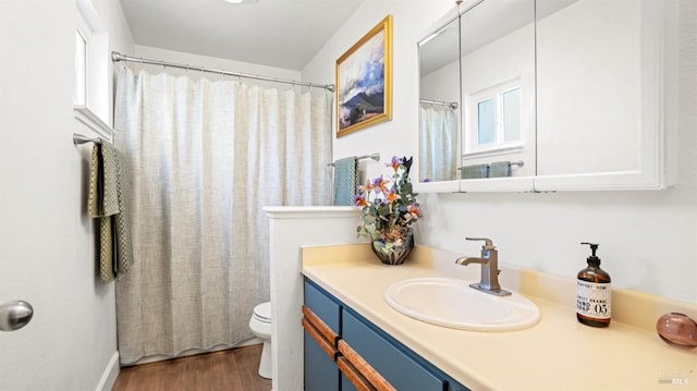 bathroom featuring toilet, a shower with curtain, vanity, and wood finished floors