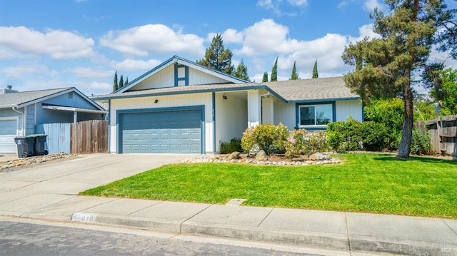 ranch-style home with a garage, driveway, a front yard, and fence